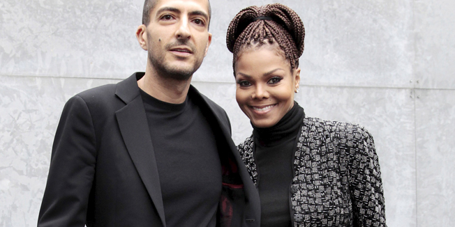 U.S. singer Janet Jackson (R) and her then boyfriend Wissam Al Mana pose for photographers as they arrive to attend the Giorgio Armani Autumn/Winter 2013 collection at Milan Fashion Week, in this file picture taken February 25, 2013.  Hinting at a possible pregnancy, Janet Jackson announced on April 6, 2016 that she was temporarily halting her world tour because of a 