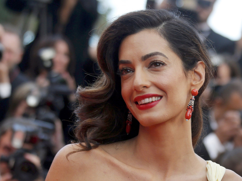 George Clooney's wife Amal poses on the red carpet as she arrives for the screening of the film 