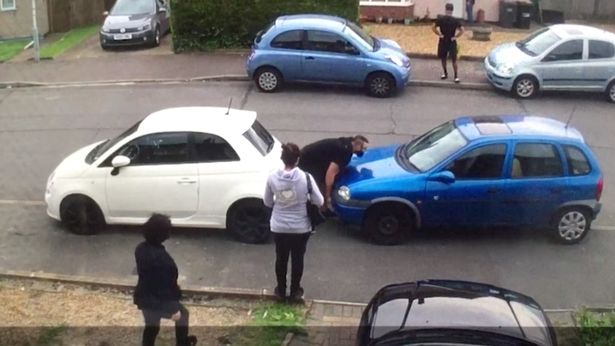 PAY-WATCH-INCREDIBLE-MOMENT-STRONGMAN-LIFTS-AND-MOVES-NEIGHBOURS-CAR-IN-PETTY-PARKING-DISPUTE
