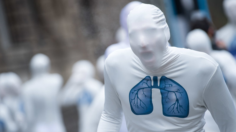 greenpeace-activists-wear-white-morphsuits-with-lungs-painted-on-them-picture-id920491770