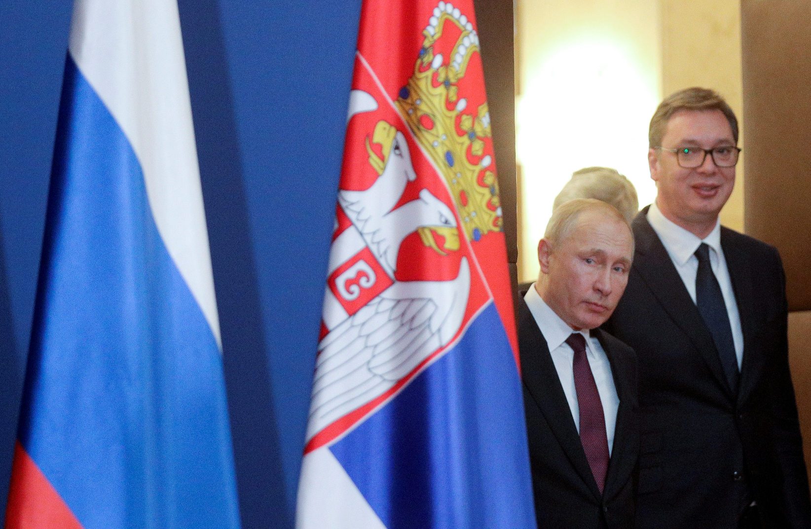Russian President Vladimir Putin and Serbian President Aleksandar Vucic arrive for a news conference in Belgrade