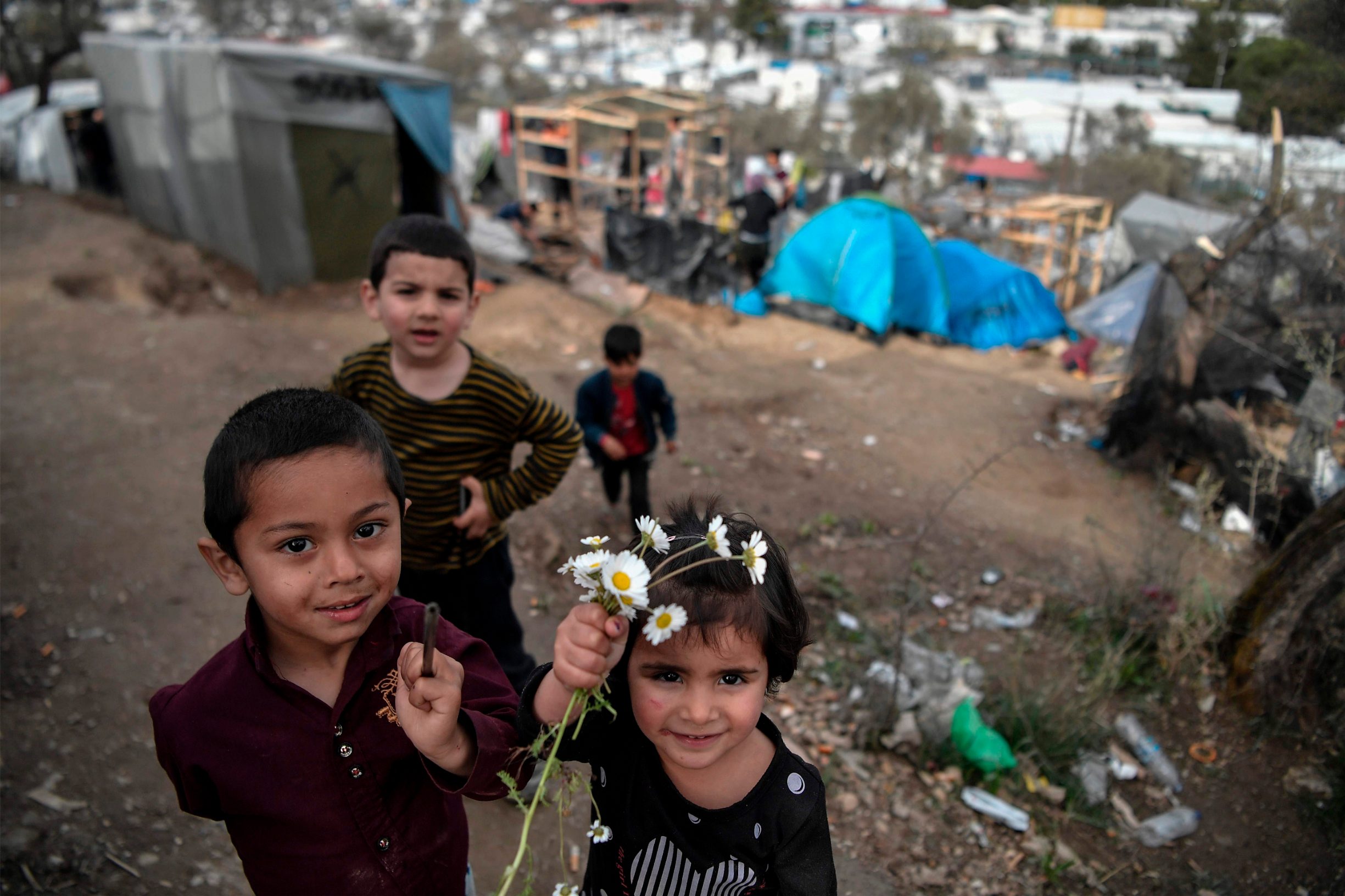 Migrant children play in the overcrowded Moria camp on the island of Lesbos on March 7, 2020. Over 1,700 migrants have landed on Lesbos and four other Aegean islands from Turkey over the past week, adding to the 38,000 already crammed into abysmal and overstretched refugee centres.