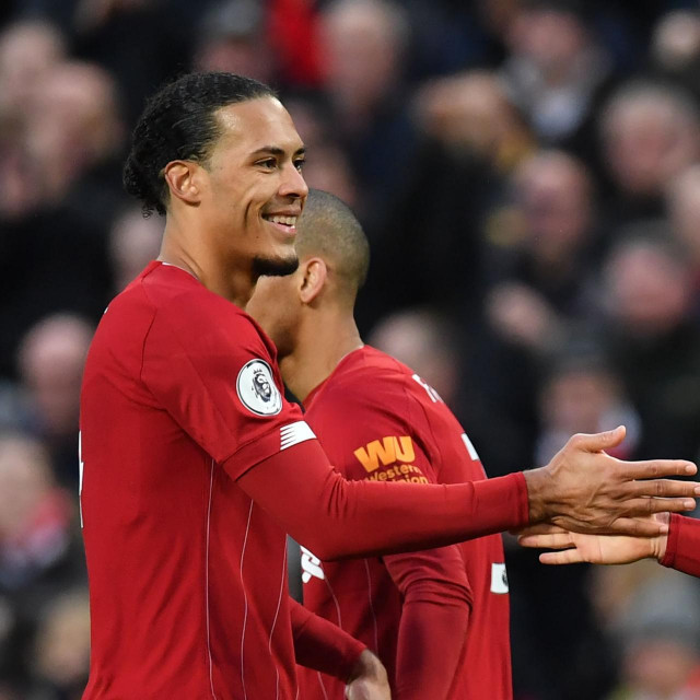 Liverpool's English midfielder Jordan Henderson (R) celebrates with Liverpool's Dutch defender Virgil van Dijk after scoring his team's second goal during the English Premier League football match between Liverpool and Southampton at Anfield in Liverpool, north west England on February 1, 2020. (Photo by Paul ELLIS/AFP)/RESTRICTED TO EDITORIAL USE. No use with unauthorized audio, video, data, fixture lists, club/league logos or 'live' services. Online in-match use limited to 120 images. An additional 40 images may be used in extra time. No video emulation. Social media in-match use limited to 120 images. An additional 40 images may be used in extra time. No use in betting publications, games or single club/league/player publications./