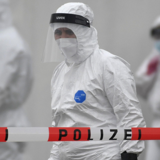 TOPSHOT - Members of a coronavirus testing station stand on the factory premises of the Westfleisch meat processing company in Hamm, western Germany, on May 10, 2020, as all workers of the company have to be tested on the novel coronavirus after a spike in cases at their slaughterhouse. - Local authorities in the western federal state of North Rhine-Westphalia announced on May 8, 2020 that reopening plans were postponed and an ”emergency mechanism” would come into effect due to high infection rates in the region. Many of the Westfleisch company's workers, partially originating from Eastern Europe and housed in shared accomodation, were tested positive on the novel coronavirus that can cause the COVID-19 disease. (Photo by Ina FASSBENDER/AFP)
