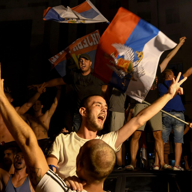 Opposition supporters celebrate on the streets after the general elections in Podgorica, early hours on August 31, 2020. - Montenegro's ruling party was a hair ahead of the main pro-Serb opposition alliance in a hotly-fought election on August 30 that left both sides without a full majority, a preliminary exit poll showed, portending uncertain coalition talks for the Adriatic nation. With little over a third of the vote share, the Democratic Party of Socialists (DPS) led by President Milo Djukanovic -- in power for some three decades -- looked set for its worst electoral showing in history. (Photo by SAVO PRELEVIC/AFP)
