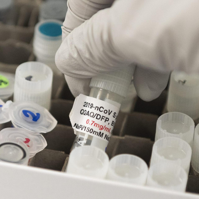 (FILES) In this file photo Dr. Nita Patel, Director of Antibody discovery and Vaccine development, lifts a vial with a potential coronavirus, COVID-19, vaccine at Novavax labs in Gaithersburg, Maryland on March 20, 2020, one of the labs developing a vaccine for the coronavirus, COVID-19. - New York Governor Andrew Cuomo said September 24, 2020 his state will conduct its own verification of any federally approved vaccination, citing concerns that the vetting process is overly politicized. ”Frankly, I'm not going to trust the federal government's opinion,” the Democratic state leader told journalists. (Photo by ANDREW CABALLERO-REYNOLDS/AFP)
