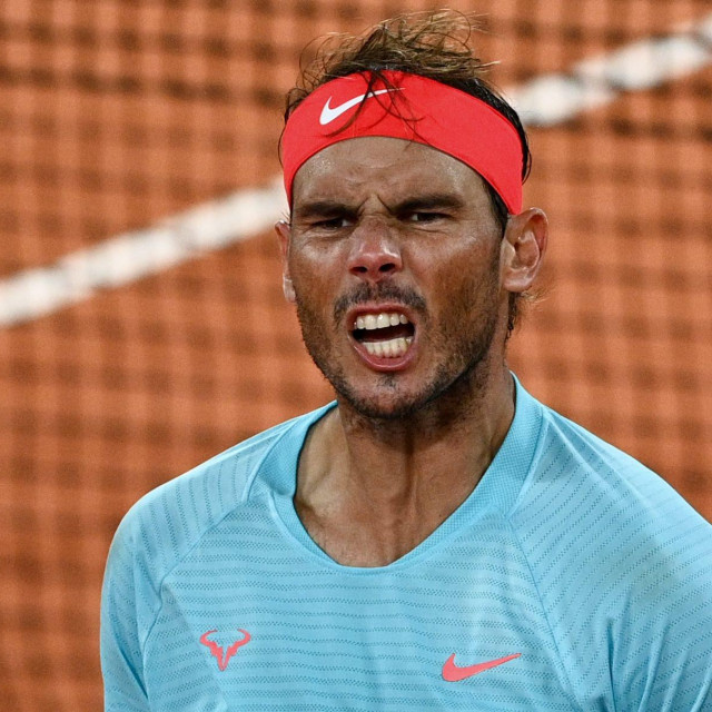 Spain's Rafael Nadal celebrates after winning against Italy's Jannik Sinner at the end of their men's singles quarter-final tennis match on Day 10 of The Roland Garros 2020 French Open tennis tournament in Paris on October 6, 2020. (Photo by Anne-Christine POUJOULAT/AFP)