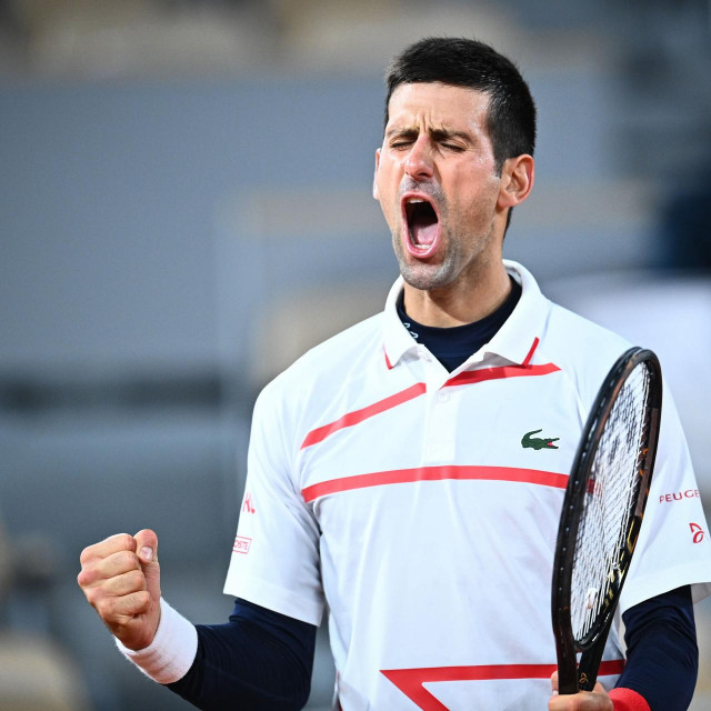 Serbia's Novak Djokovic celebrates after winning against Spain's Pablo Carreno Busta during their men's singles quarter-final tennis match on Day 11 of The Roland Garros 2020 French Open tennis tournament in Paris on October 7, 2020. (Photo by Anne-Christine POUJOULAT/AFP)