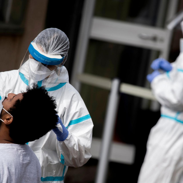 A man undergoes a swab test for coronavirus at a drive-through testing site of the Santa Maria della Pieta hospital in Rome on October 12, 2020 (Photo by Tiziana FABI/AFP)