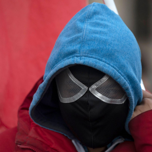 A man wears a mask as he takes part in a protest against Austrian government's restrictions implied due to the new coronavirus Covid-19, outside of the Hofburg palace in Vienna, Austria on October 31, 2020. - Austria's government announced a second mass shutdown next week until the end of November along with a curfew which will come into force from 8pm to 6am. (Photo by JOE KLAMAR/AFP)