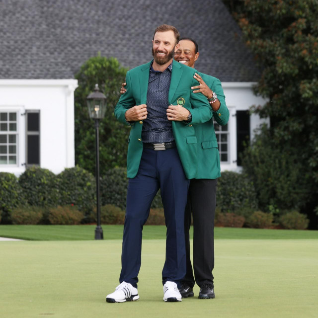 AUGUSTA, GEORGIA - NOVEMBER 15: Dustin Johnson of the United States is awarded the Green Jacket by Masters champion Tiger Woods of the United States during the Green Jacket Ceremony after winning the Masters at Augusta National Golf Club on November 15, 2020 in Augusta, Georgia. Rob Carr/Getty Images/AFP
== FOR NEWSPAPERS, INTERNET, TELCOS & TELEVISION USE ONLY ==