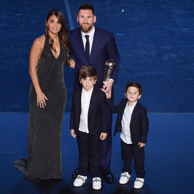 (FILES) In this file photo taken on September 23, 2019 Best FIFA Men's Player of 2019, Argentina and Barcelona forward Lionel Messi poses with his wife Antonella Roccuzzo Messi and their children at the end of The Best FIFA Football Awards ceremony in Milan. - Six-time Ballon d'Or winner Lionel Messi told Barcelona he wants to leave -- on a free transfer -- in a ”bombshell” fax yesterday that is expected to spark a legal battle over a buy-out clause worth hundreds of millions of dollars. (Photo by Marco Bertorello/POOL/AFP)