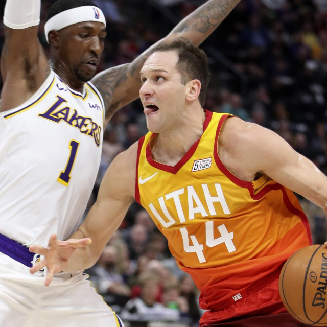 Utah Jazz forward Bojan Bogdanovic (R) drives to the basket on Los Angeles Lakers guard Kentavious Caldwell-Pope (L) during an NBA game in Salt Lake City, Utah on December 4, 2019. (Photo by GEORGE FREY/AFP)