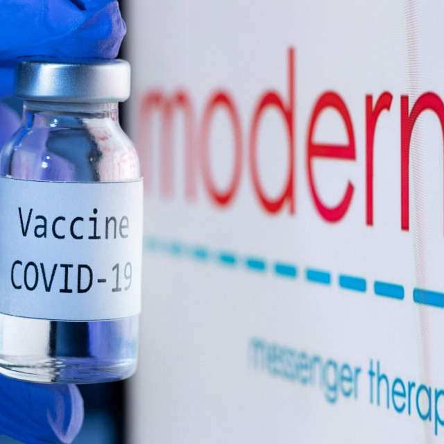 (FILES) This file photo taken on November 18, 2020 shows a bottle reading ”Vaccine Covid-19” next to the Moderna biotech company logo. - The EU's medicines watchdog said on December 17, 2020 that it had moved forward the date for a decision on authorising Moderna's coronavirus vaccine to January 6 from January 12. The Amsterdam-based European Medicines Agency said US-based Moderna had sent extra data ahead of schedule, so the regulator had ”scheduled an extraordinary meeting on 6 January 2021 to conclude its assessment, if possible”. (Photo by JOEL SAGET/AFP)/-- IMAGE RESTRICTED TO EDITORIAL USE - STRICTLY NO COMMERCIAL USE --
