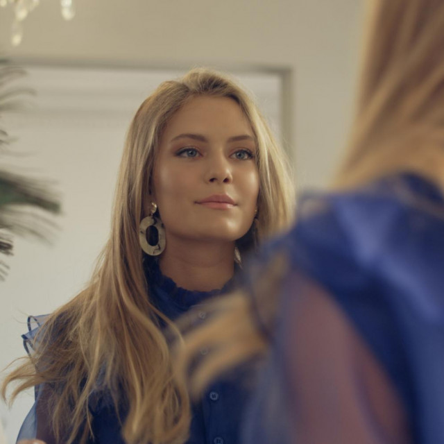 Party preparations. Woman enjoying her mirror reflection