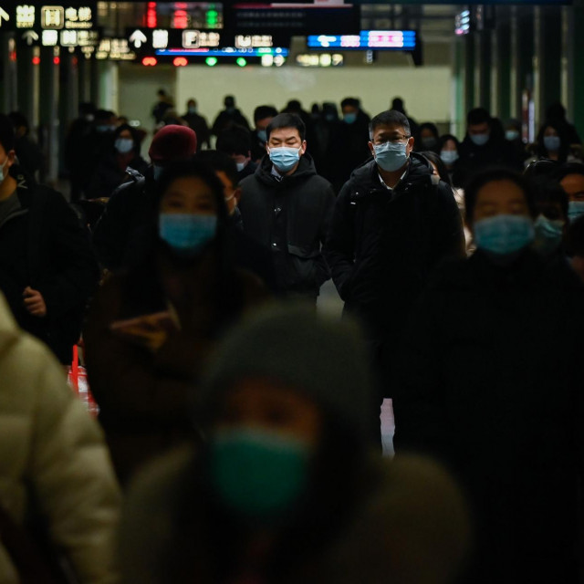 Passengers walk in a subway station in Beijing on January 18, 2021. (Photo by WANG Zhao/AFP)