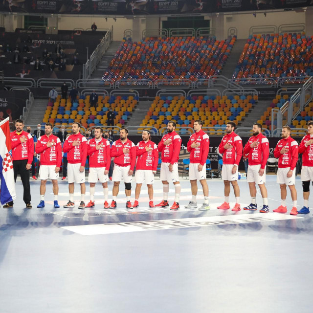 Croatia‘s players listen to their national anthem ahead of the 2021 World Men‘s Handball Championship match between Group II teams Denmark and Croatia at the Cairo Stadium Sports Hall in the Egyptian capital on January 25, 2021. (Photo by MOHAMED ABD EL GHANY/POOL/AFP)