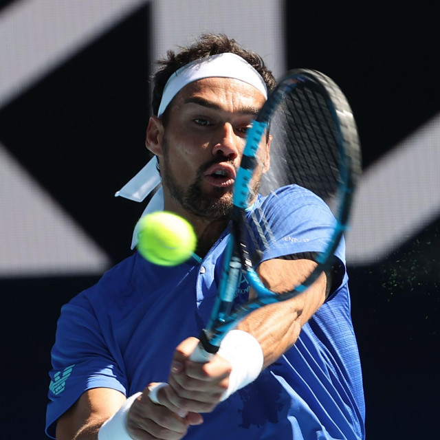 Italy's Fabio Fognini hits a return against France's Benoit Paire during their group C men's singles tennis match on day two of the 2021 ATP Cup in Melbourne on February 3, 2021. (Photo by DAVID GRAY/AFP)/-- IMAGE RESTRICTED TO EDITORIAL USE - STRICTLY NO COMMERCIAL USE --