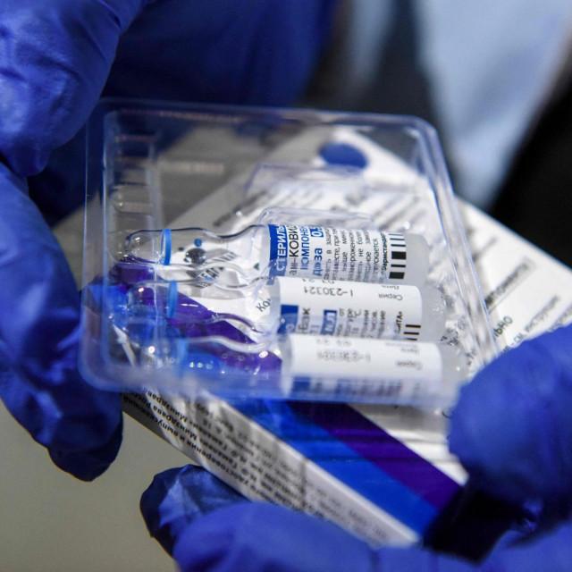 A nurse takes out vials of the Sputnik V vaccine against the Covid-19 at the Boris Trajkovski sports hall in Skopje as the country start its vaccination campaign, after months of difficulties on April 16, 2021. - Moscow announced on April 14, 2021 the start of production of its Sputnik V coronavirus vaccine in Serbia, the first European country outside Russia and Belarus to manufacture the vaccine. (Photo by Robert ATANASOVSKI/AFP)