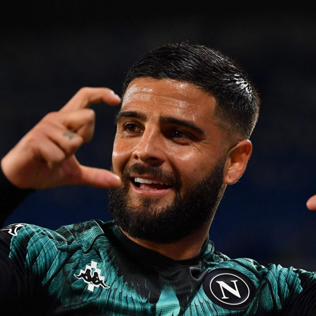 Napoli's Italian forward Lorenzo Insigne celebrates after Inter scored an own goal to open the scoring during the Italian Serie A football match Napoli vs Inter on April 18, 2021 at the Diego Maradona (San Paolo) stadium in Naples. (Photo by Tiziana FABI/AFP)