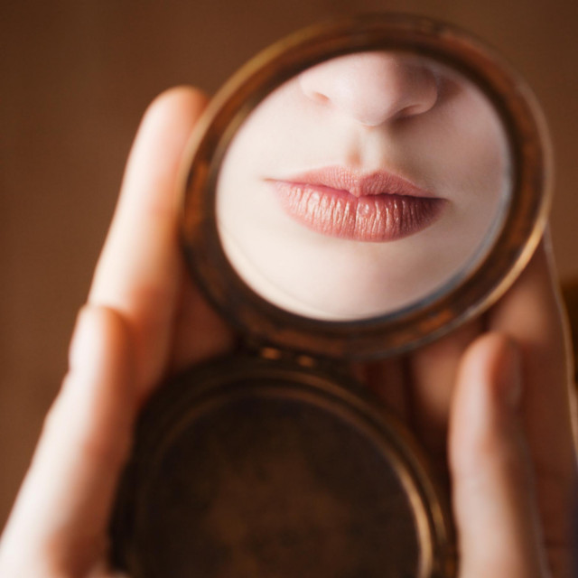 Girl lips in reflecting in a mirror