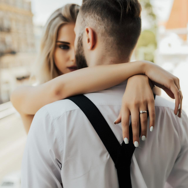 Young amorous couple hugging. Sexy couple at home. Hugging, kissing and enjoying spending time together. Couple in love passionately hugging.