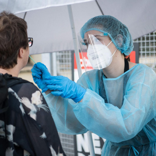 A woman is being tested for the the coronavirus/COVID-19 at a mobile test station in Berlin's Kreuzberg district on July 30, 2021, amid the ongoing coronavirus/COVID-19 pandemic. (Photo by STEFANIE LOOS/AFP)