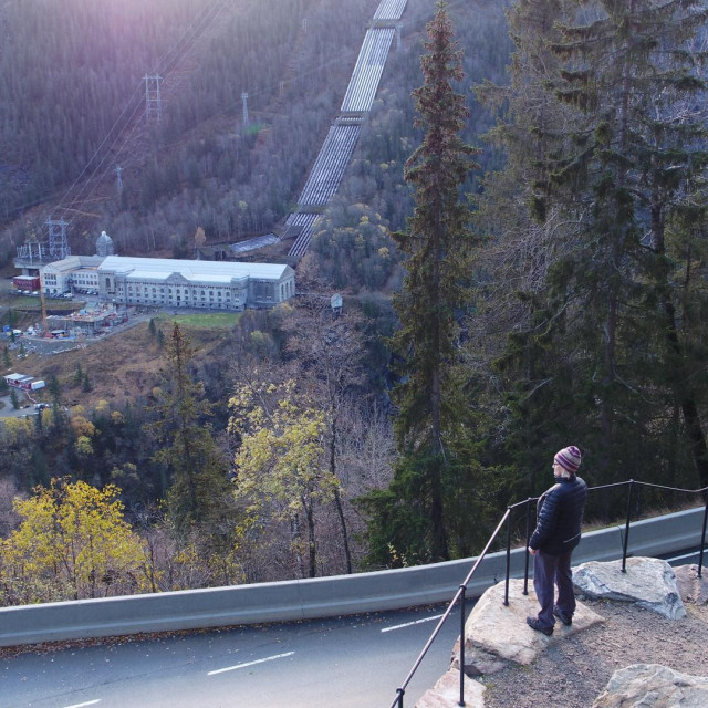 Exhibition manager looking down from the road at the Vemork Plant. (National Geographic)