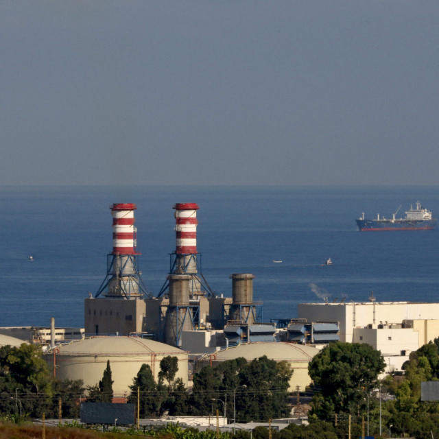 (FILES) In this file photo taken on September 18, 2021, an oil tanker carrying fuel oil from Iraq, is seen anchored near the Zahrani power plant in Zahrani near the southern Lebanese city of Sidon (Saida). - Lebanon was plunged into a total blackout today after two main power stations went offline because they ran out of fuel, the state electricity corporation said. (Photo by Mahmoud ZAYYAT/AFP)