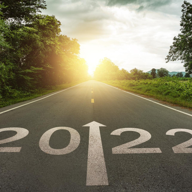 New year 2022 or straightforward concept. Text 2022 written on the road in the middle of asphalt road at sunset.Concept of planning and challenge, business strategy, opportunity,hope, new life change
