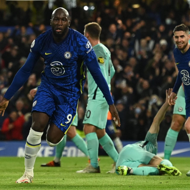 Chelsea's Belgian striker Romelu Lukaku celebrates scoring his team's first goal during the English Premier League football match between Chelsea and Brighton and Hove Albion at Stamford Bridge in London on December 29, 2021. (Photo by Glyn KIRK/AFP)/RESTRICTED TO EDITORIAL USE. No use with unauthorized audio, video, data, fixture lists, club/league logos or 'live' services. Online in-match use limited to 120 images. An additional 40 images may be used in extra time. No video emulation. Social media in-match use limited to 120 images. An additional 40 images may be used in extra time. No use in betting publications, games or single club/league/player publications./