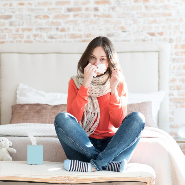 Pleasant gloomy woman suffering from cold
