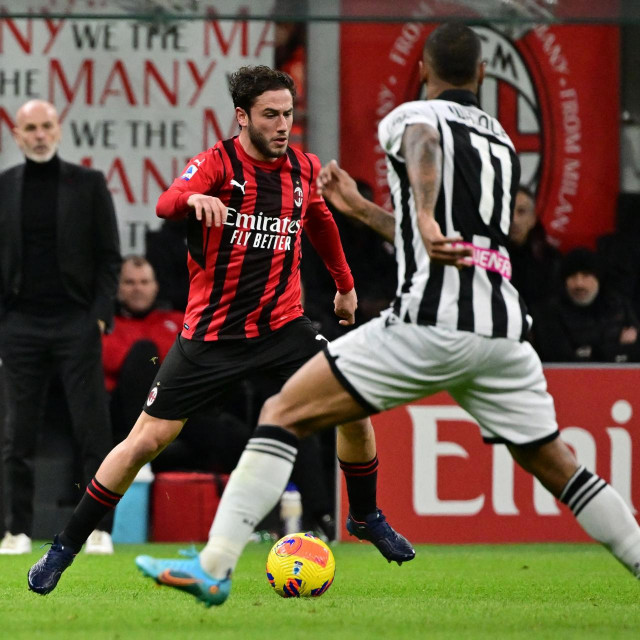 AC Milan's Italian defender Davide Calabria (L) controls the ball as Udinese's Brazilian midfielder Walace defends during the Italian Serie A football match between AC Milan and Udinese at The Giuseppe Meazza Stadium - also called San Siro - in Milan, on February 25, 2022. (Photo by MIGUEL MEDINA/AFP)

