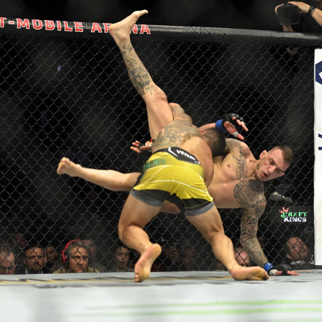 LAS VEGAS, NEVADA - MARCH 05: Rafael Dos Anjos of Brazil and Rafael Fiziev of Kazakhstan fight in their lightweight bout during UFC 272 at T-Mobile Arena on March 05, 2022 in Las Vegas, Nevada. David Becker/Getty Images/AFP
== FOR NEWSPAPERS, INTERNET, TELCOS & TELEVISION USE ONLY ==