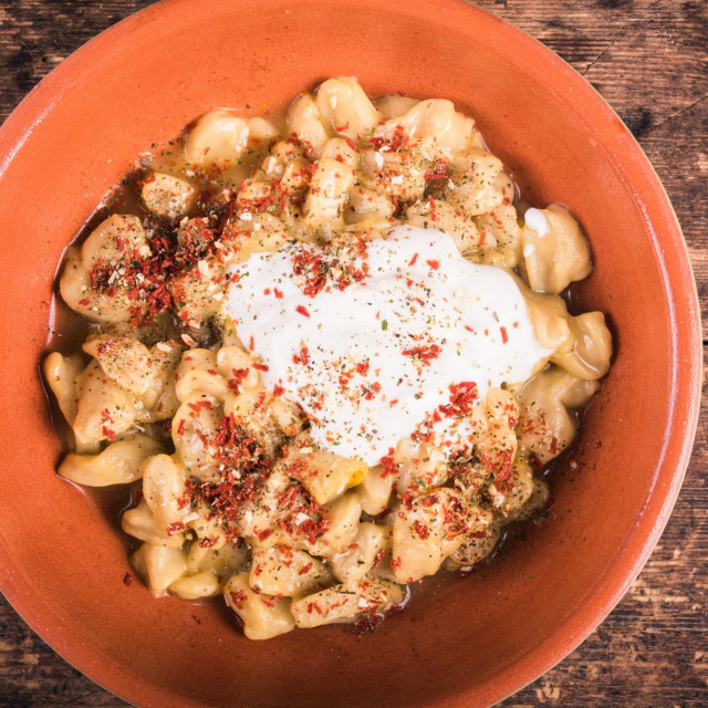 Czech pasta - dumplings with sour cream in a bowl, top view