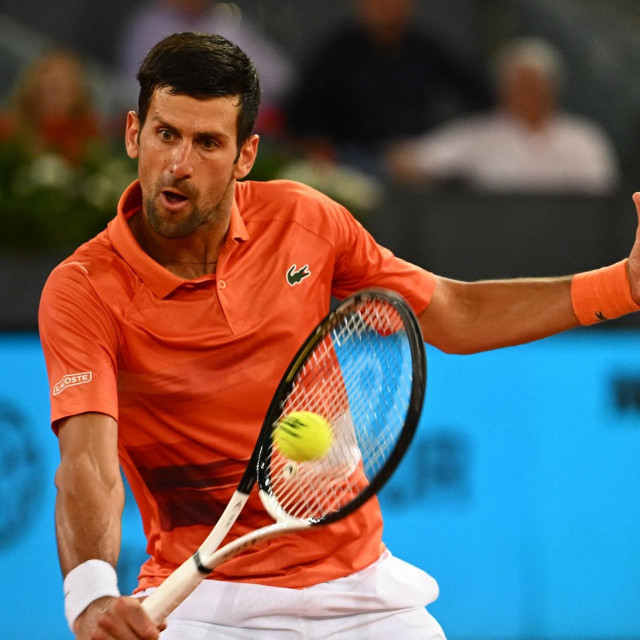 Serbia's Novak Djokovic returns the ball to France's Gael Monfils during their 2022 ATP Tour Madrid Open tennis tournament singles match at the Caja Magica in Madrid on May 3, 2022. (Photo by GABRIEL BOUYS/AFP)