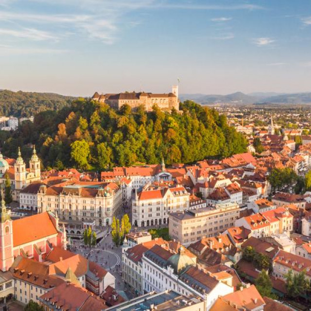Aerial panoramic view of Ljubljana, capital of Slovenia in warm afternoon sun.