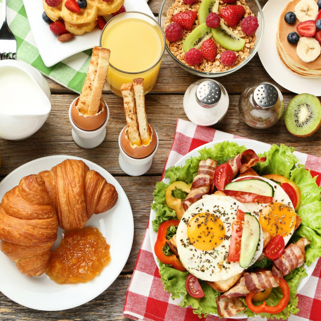 Tasty breakfast on wooden table