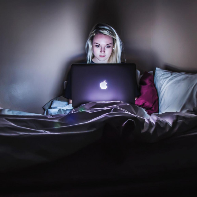 woman sitting on bed