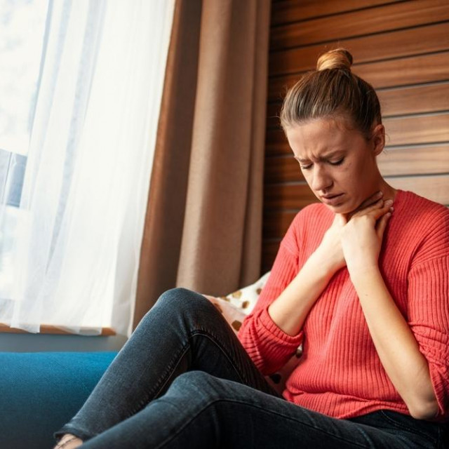 Unhealthy young woman touch neck hard to swallow having discomfort or painful feeling, unwell sad female employee suffering from angina or tonsillitis, sore throat, experience loss of voice