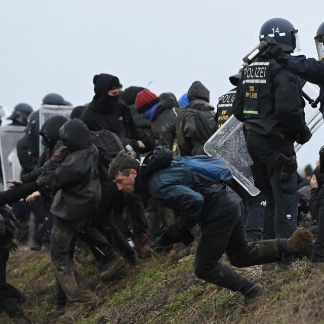 Prosvjednik trči pored policije tijekom velikog prosvjeda