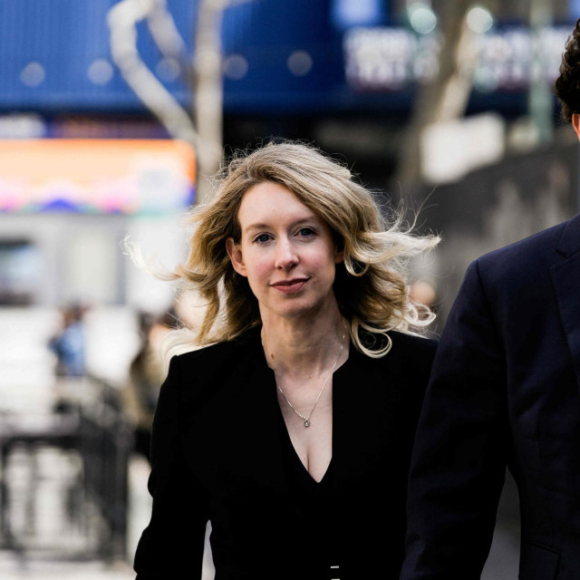 (FILES) In this file photo taken on March 17, 2023 former Theranos CEO Elizabeth Holmes alongside her boyfriend Billy Evans, walks back to her hotel following a hearing at the Robert E. Peckham U.S. Courthouse in San Jose, California. - Fallen US biotech star Elizabeth Holmes will stay out of prison for now after her lawyers on April 25, 2023 lodged a last-minute appeal to avoid starting her 11 year sentence. Holmes was set to begin her sentence on April 27 after being found guilty in January 2022 for defrauding investors with her Silicon Valley start-up Theranos. (Photo by Philip Pacheco/GETTY IMAGES NORTH AMERICA/AFP)