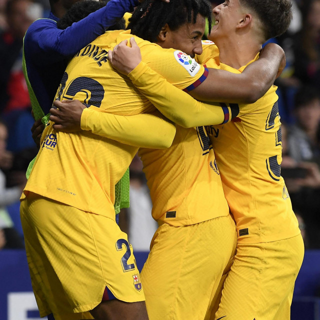 Barcelona‘s French defender Jules Kounde (C) celebrates scoring his team‘s fourth goal during the Spanish league football match between RCD Espanyol and FC Barcelona at the RCDE Stadium in Cornella de Llobregat on May 14, 2023. (Photo by Josep LAGO/AFP)