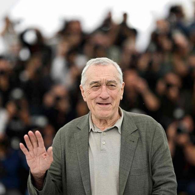 US actor Robert De Niro waves during a photocall for the film ”Bread and Roses” at the 76th edition of the Cannes Film Festival in Cannes, southern France, on May 21, 2023. (Photo by Patricia DE MELO MOREIRA/AFP)