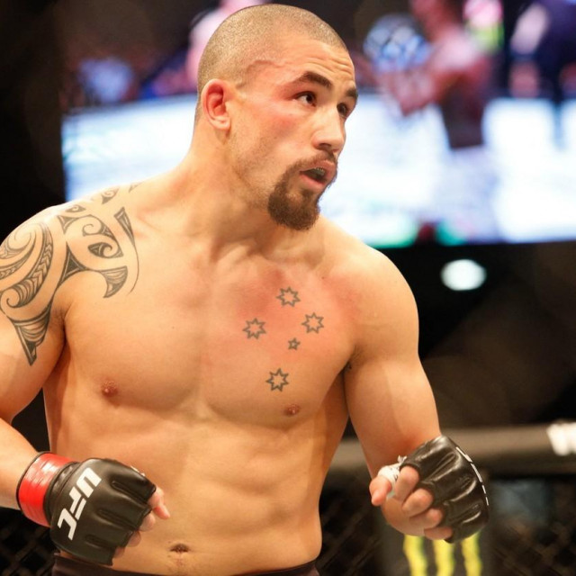 Robert Whittaker of Australia in action against Israel Adesanya of New Zealand during the middleweight title bout of the UFC 243 fight night in Melbourne on October 6, 2019.,Image: 475307379, License: Rights-managed, Restrictions: -- IMAGE RESTRICTED TO EDITORIAL USE - STRICTLY NO COMMERCIAL USE --, Model Release: no, Credit line: ASANKA BRENDON RATNAYAKE/AFP/Profimedia