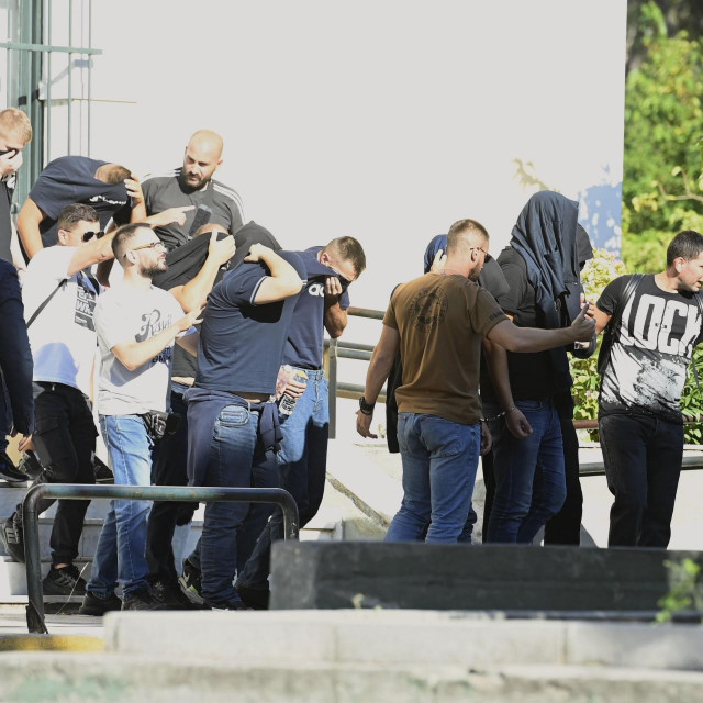 Izvođenje grupe uhićenih navijača iz zgrade Suda