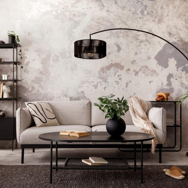 The stylish compostion at living room interior with design gray sofa, armchair, black coffee table, lamp and elegant personal accessories. Loft and industrial interior. Template.