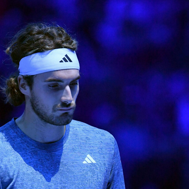 Greece‘s Stefanos Tsitsipas reacts as he withdraws from his match against Denmark‘s Holger Rune during their round-robin match on day 3 of the ATP Finals tennis tournament in Turin on November 14, 2023. (Photo by Tiziana FABI/AFP)