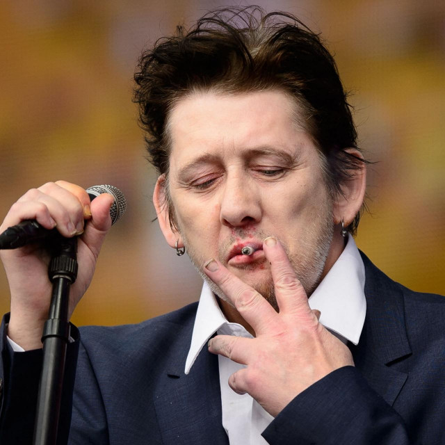 (FILES) Shane MacGowan of British group The Pogues performs on stage at the British Summer Time festival in Hyde Park in central London, on July 5, 2014. Shane MacGowan, songwriter and lead singer of folk-punk group The Pogues, has died aged 65 after a long illness, his wife announced on November 30, 2023. (Photo by LEON NEAL/AFP)