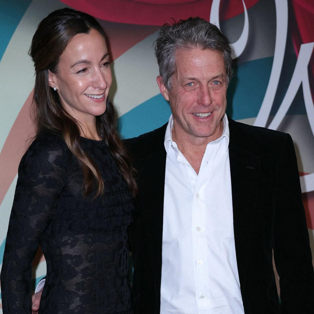 English actor Hugh Grant and his wife Anna Elisabet Eberstein pose on the red carpet upon arrival for the Premiere of the film ”Wonka” at the UGC Normandie cinema in Paris, on December 1, 2023. (Photo by Thomas SAMSON/AFP)
